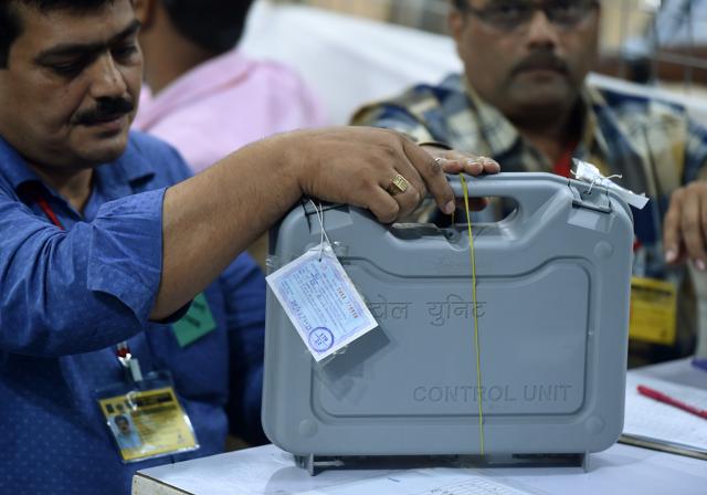Indian officials inspect an Electronic Voting Machine (EVM) during a votes counting process at a booth in Mumbai on May 23, 2019. (AFP) Indian officials inspect an Electronic Voting Machine (EVM) during a votes counting process at a booth in Mumbai on May 23, 2019. (AFP)