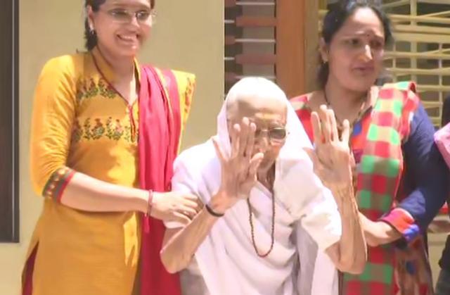 Prime Minister Narendra Modi's mother Heeraben Modi greets the media outside her residence in Gandhinagar on Thursday. (ANI)
