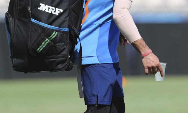 Southampton : India's captain Virat Kohli carries a glass of ice water to relieve pain in his right thumb after hurting it during a training session ahead of their Cricket World Cup match against South Africa at Ageas Bowl in Southampton, England, Saturday, June 1, 2019. (AP) Southampton : India's captain Virat Kohli carries a glass of ice water to relieve pain in his right thumb after hurting it during a training session ahead of their Cricket World Cup match against South Africa at Ageas Bowl in Southampton, England, Saturday, June 1, 2019. (AP)