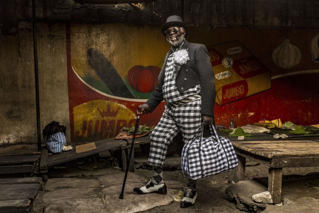 Yamea, 58, who has been a sapeur for half a century, brings colour and joie de vivre to his community. He has nine children and works as a bricklayer. His hat is his favourite item of clothing (Tariq Zaidi) Yamea, 58, who has been a sapeur for half a century, brings colour and joie de vivre to his community. He has nine children and works as a bricklayer. His hat is his favourite item of clothing (Tariq Zaidi)
