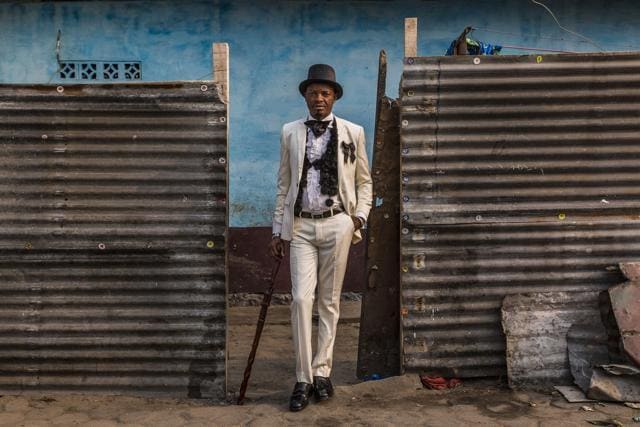 Kass, 42, has been a sapeur for 20 years. He has three children and sells clothes in a small shop. His favourite item of clothing is his expensive JM Weston shoes (Tariq Zaidi) Kass, 42, has been a sapeur for 20 years. He has three children and sells clothes in a small shop. His favourite item of clothing is his expensive JM Weston shoes (Tariq Zaidi)