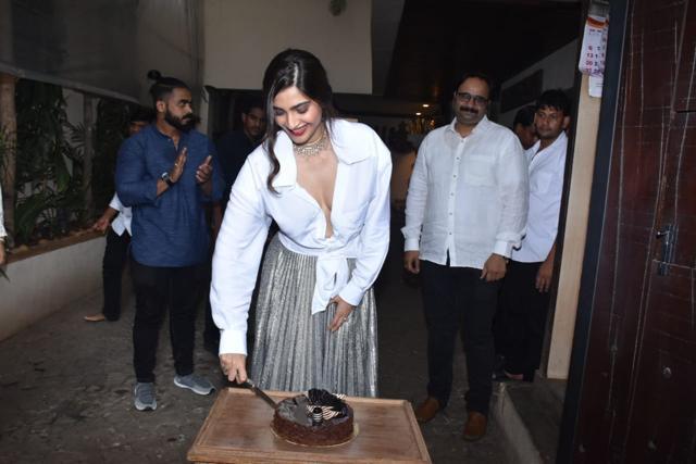 Sonam Kapoor cuts a cake. Sonam Kapoor cuts a cake.