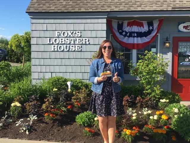 Alicia Jessop poses for a photo with a lobster roll at Fox's Lobster House in York, Maine. (Alicia Jessop/@rulingsports via AP)