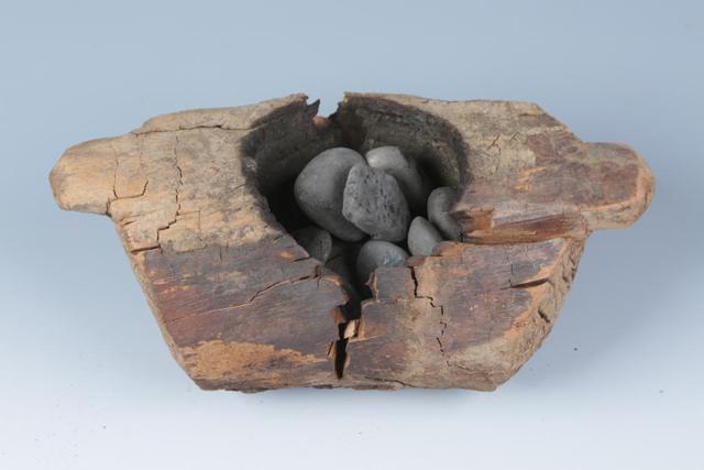 In this photo received by AFP on June 11, 2019 from the Institute of Archaeology, Chinese Academy of Social Sciences, a wooden brazier (burner) and stones used to burn cannabis that was excavated from the Jirzankal cemetery, located northeast of Qushiman Village in the Tashkurgan Tajik Autonomous County of Xinjiang province, is displayed. (AFP photo) In this photo received by AFP on June 11, 2019 from the Institute of Archaeology, Chinese Academy of Social Sciences, a wooden brazier (burner) and stones used to burn cannabis that was excavated from the Jirzankal cemetery, located northeast of Qushiman Village in the Tashkurgan Tajik Autonomous County of Xinjiang province, is displayed. (AFP photo)