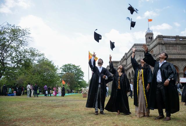 Students celebrate at the 115th convocation ceremony of the Savitribai Phule Pune University on Friday. (Milind Saurkar/HT Photo)