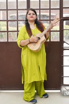 Nitu Singh poses with her Ukelele, which she says is her happy place. (Gokul VS/HT Photo)