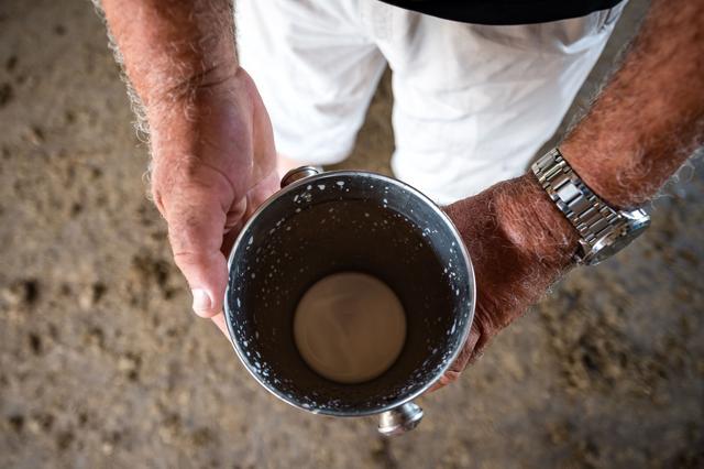 A farmer shows a bucket with donkey milk in Serbia. (AFP) A farmer shows a bucket with donkey milk in Serbia. (AFP)