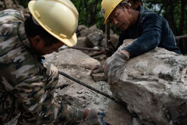Workers placing stones at a restored part of the Great Wall. (AFP) Workers placing stones at a restored part of the Great Wall. (AFP)