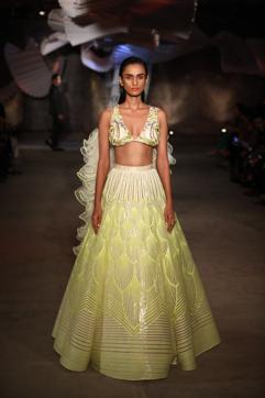 MEHENDI MAGIC: A geometric and striped neon lehenga paired with a bralette which has a ruffled cape detailing. (Photo: Raajessh Kashyap/HT)