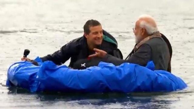 PM Modi is seen in a makeshift raft with show host Bear Grylls (Photo credit: Twitter/Screengrab) PM Modi is seen in a makeshift raft with show host Bear Grylls (Photo credit: Twitter/Screengrab)