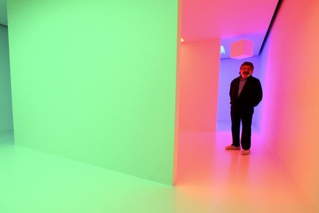 Venezuelan artist Carlos Cruz-Diez poses for a portrait inside his Chromosaturation environment during the press preview in New York. (AP)
