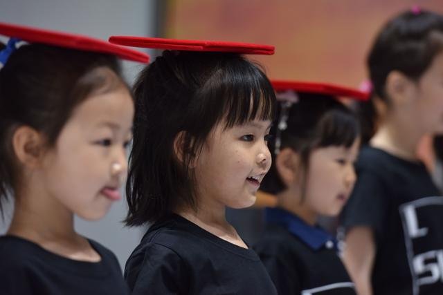 Child models practicing with books on their heads at a modelling school in Beijing. (AFP) Child models practicing with books on their heads at a modelling school in Beijing. (AFP)
