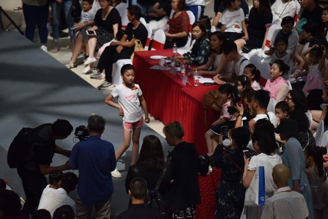 A child model parading on the catwalk at a child model contest in Beijing. (AFP) A child model parading on the catwalk at a child model contest in Beijing. (AFP)