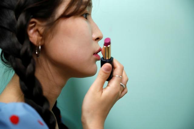 Kang Na-ra, a North Korean defector who is now a beauty YouTuber, puts on a lipstick made by North Korea, in Seoul, South Korea. (REUTERS) Kang Na-ra, a North Korean defector who is now a beauty YouTuber, puts on a lipstick made by North Korea, in Seoul, South Korea. (REUTERS)