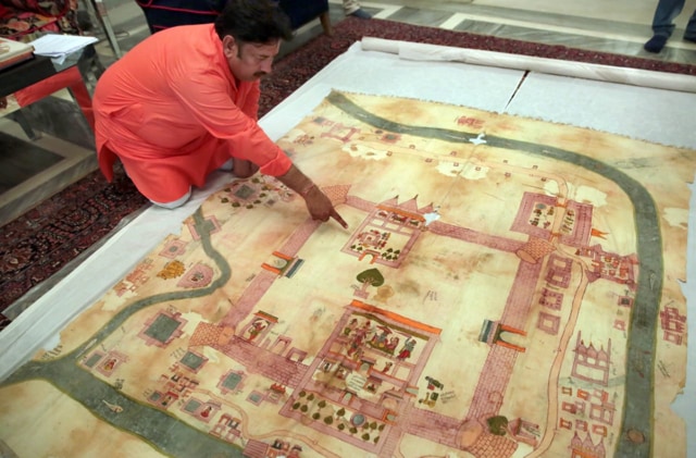 Ramu Ramdev, OSD at the City Palace, points out Lord Rama’s birth place in an old dilapidated map of Ayodhya being taken out from archives of erstwhile royal family of Jaipur, at City Palace, in Jaipur. Photo by Himanshu Vyas/Hindustan Times) Ramu Ramdev, OSD at the City Palace, points out Lord Rama’s birth place in an old dilapidated map of Ayodhya being taken out from archives of erstwhile royal family of Jaipur, at City Palace, in Jaipur. Photo by Himanshu Vyas/Hindustan Times)