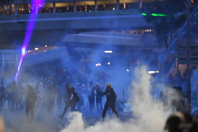 Protesters throw back tear gas cannisters fired by the police in Tai Wai in the New Territories of Hong Kong. (AFP) Protesters throw back tear gas cannisters fired by the police in Tai Wai in the New Territories of Hong Kong. (AFP)