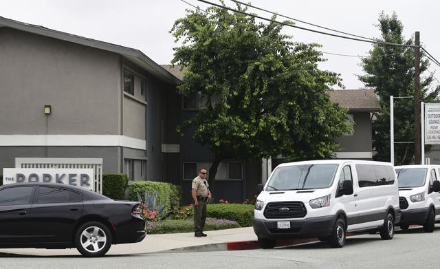 An officer from the Los Angeles County Sheriffs Department mans his position beside the two white vans carrying jurors visiting an apartment complex for the murder trial of Michael Gargiulo case, in El Monte, California. (AP) An officer from the Los Angeles County Sheriffs Department mans his position beside the two white vans carrying jurors visiting an apartment complex for the murder trial of Michael Gargiulo case, in El Monte, California. (AP)