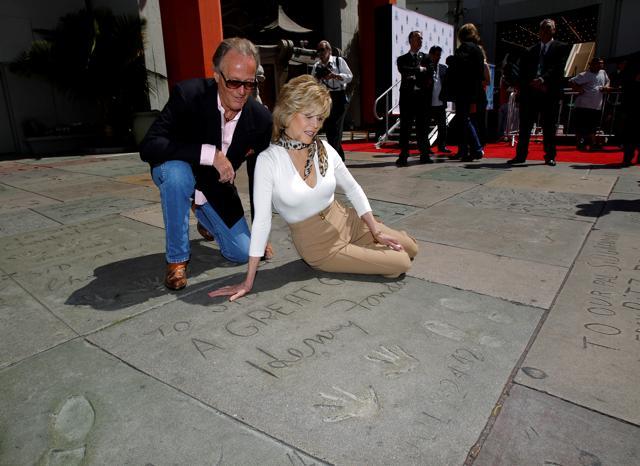 Jane Fonda and her brother actor Peter Fonda look at their father's, actor Henry Fonda, handprints and footprints after her hand and footprint ceremony in the forecourt of the Chinese theatre in Hollywood, California April 27, 2013. (REUTERS) Jane Fonda and her brother actor Peter Fonda look at their father's, actor Henry Fonda, handprints and footprints after her hand and footprint ceremony in the forecourt of the Chinese theatre in Hollywood, California April 27, 2013. (REUTERS)