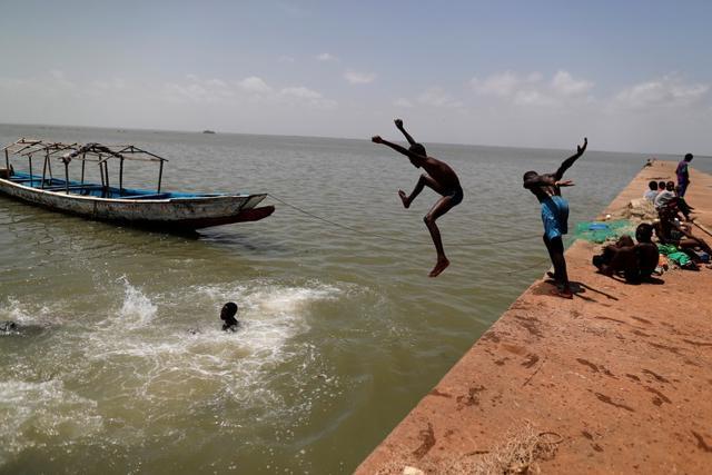 Boys swim in the waters of Gambia river in Jufureh, Albreda port, Gambia July 20, 2019 a town where slaves were shipped from by slave traders. (REUTERS) Boys swim in the waters of Gambia river in Jufureh, Albreda port, Gambia July 20, 2019 a town where slaves were shipped from by slave traders. (REUTERS)