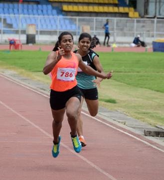 Kirti Bhoite (orange) from Palghar wins the girls’ 100 m final at Balewadi. (Milind Saurkar/HT Photo)