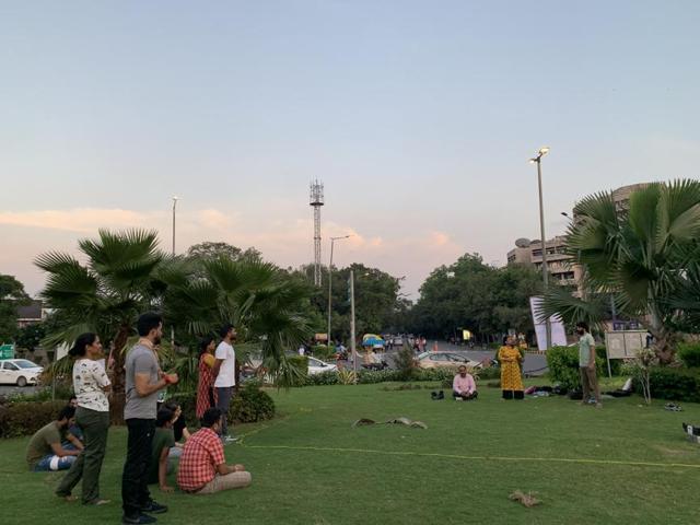 A group of actors watch fellow actors rehearse for a play at Mandi House traffic circle garden. (HT Photo ) A group of actors watch fellow actors rehearse for a play at Mandi House traffic circle garden. (HT Photo )