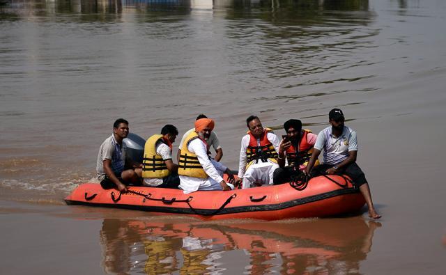 Member of Parliament from Jalandhar constituency, Santokh Singh Chaudhary inspects the flooded area at Giddar Pindi village in Lohian , Punjab, August 23, 2019. (ANI )