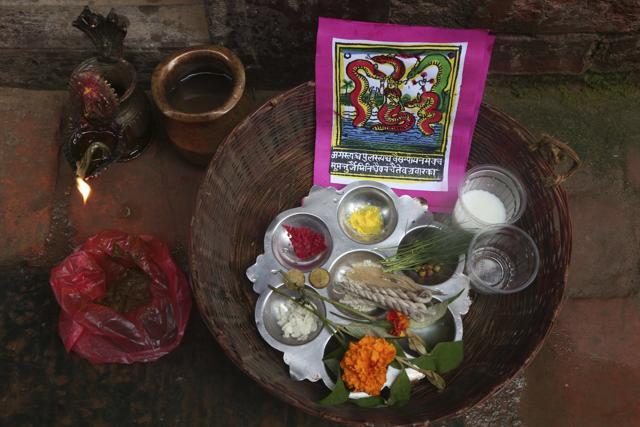 A traditional painting is seen in a basket containing materials used for rituals during Naag Panchami festival in Bhaktapur, Nepal. (AP) A traditional painting is seen in a basket containing materials used for rituals during Naag Panchami festival in Bhaktapur, Nepal. (AP)