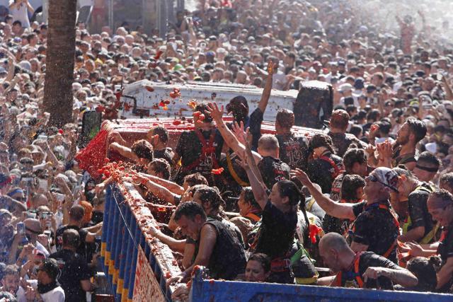 Revellers throw tomatoes at each other during the annual "Tomatina", tomato fight fiesta in the village of Bunol near Valencia, Spain, Wednesday, Aug. 28, 2019. (AP Photo/Alberto Saiz) (AP) Revellers throw tomatoes at each other during the annual "Tomatina", tomato fight fiesta in the village of Bunol near Valencia, Spain, Wednesday, Aug. 28, 2019. (AP Photo/Alberto Saiz) (AP)
