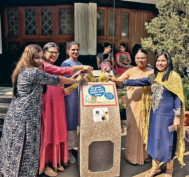 Monisha Narke (second from left) depositing tetra pak cartons along with other women Monisha Narke (second from left) depositing tetra pak cartons along with other women