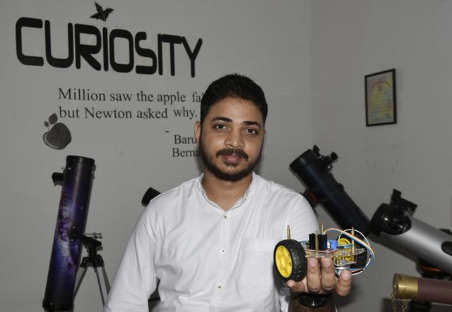 Sarvesh Bhardwaj, who runs an astronomy company, holds a model of the Chandrayaan 2 rover, at his office in Delhi (Vipin Kumar/HT PHOTO)