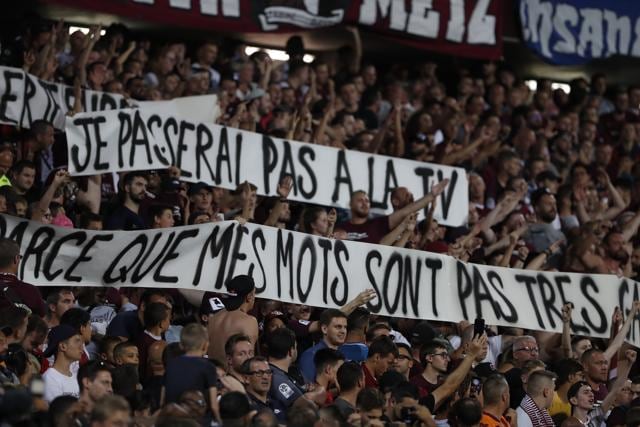 Metz's supporters hold banners with homophobic connotation (AP) Metz's supporters hold banners with homophobic connotation (AP)