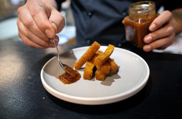 Chef Mario Barnard plates Mopane worm and polenta fries with tomato chilli chutney. (REUTERS) Chef Mario Barnard plates Mopane worm and polenta fries with tomato chilli chutney. (REUTERS)