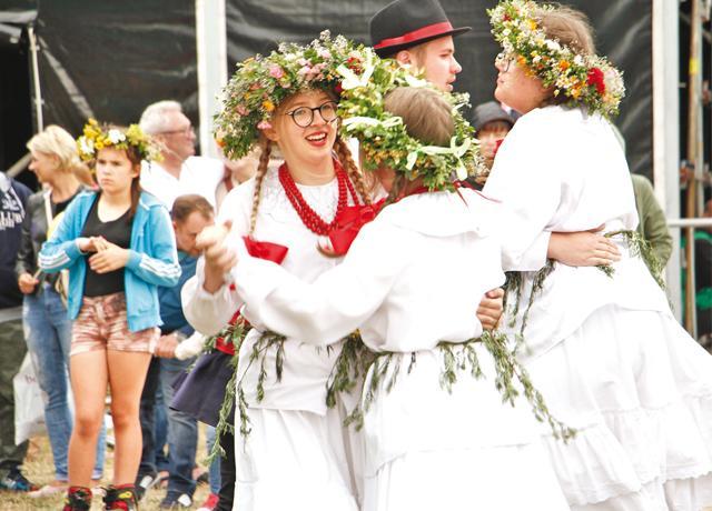 Couples dance to lively folk tunes to celebrate the summer solstice Couples dance to lively folk tunes to celebrate the summer solstice