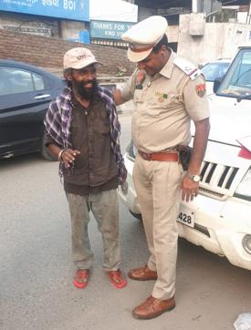 ASI Ashok Kumar says the smiles of the underprivileged after wearing slippers gives him immense satisfaction. (HT PHOTO)