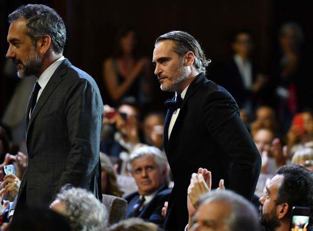 US director Todd Phillips (L), followed by US actor Joaquin Phoenix, gets up to receive the Golden Lion award for Best Film for the movie Joker during the awards ceremony of the 76th Venice Film Festival on September 7, 2019 at Venice Lido. (AFP) US director Todd Phillips (L), followed by US actor Joaquin Phoenix, gets up to receive the Golden Lion award for Best Film for the movie Joker during the awards ceremony of the 76th Venice Film Festival on September 7, 2019 at Venice Lido. (AFP)