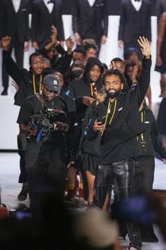 Kerby Jean-Raymond waves to attendees at the Pyer Moss collection presentation during Fashion Week, Sunday, Sept. 8, 2019 in New York. (AP Photo/Kevin Hagen) (AP) Kerby Jean-Raymond waves to attendees at the Pyer Moss collection presentation during Fashion Week, Sunday, Sept. 8, 2019 in New York. (AP Photo/Kevin Hagen) (AP)