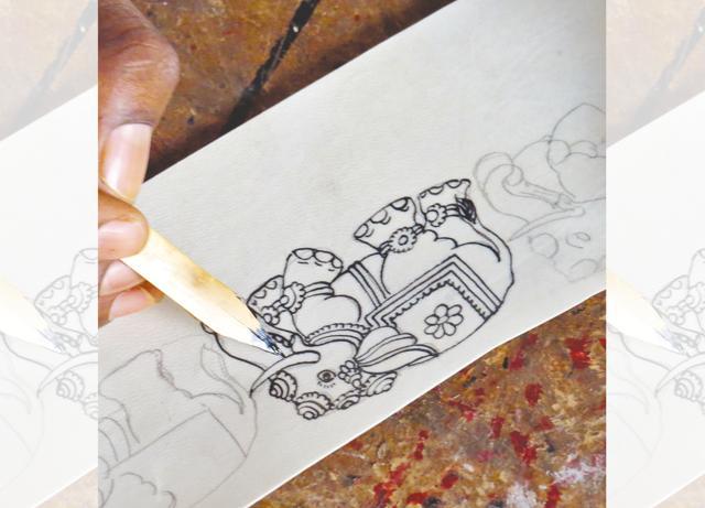 A pen made of bamboo is used to paint on leather (goat hide) by the artists A pen made of bamboo is used to paint on leather (goat hide) by the artists