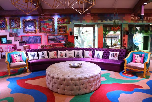 The Bigg Boss 13 living room has quirky photo frames and a colourful setting.