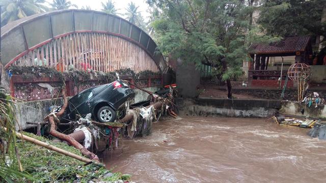 A car in a drain in Pune. (HT Photo ) A car in a drain in Pune. (HT Photo )