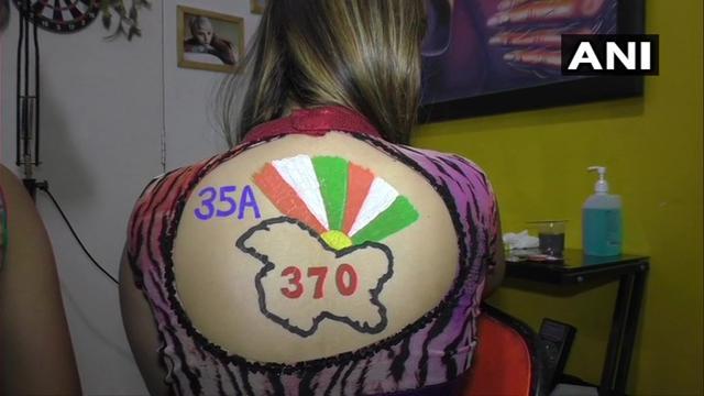 A woman showing off her body paint on the occasion of Navratri 2019. (Twitter/ANI) A woman showing off her body paint on the occasion of Navratri 2019. (Twitter/ANI)