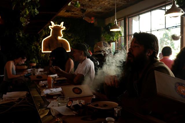 Customers smoke at Lowell Farms, America's first official Cannabis Cafe offering farm-to-table dining and smoking of cannabis. (REUTERS) Customers smoke at Lowell Farms, America's first official Cannabis Cafe offering farm-to-table dining and smoking of cannabis. (REUTERS)