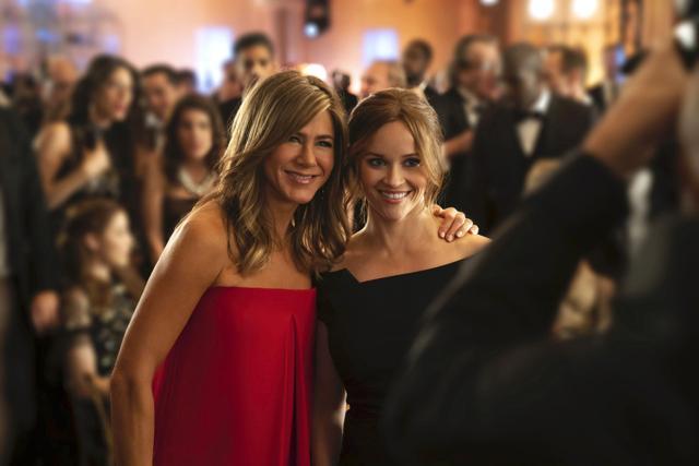 This image released by Apple TV Plus, Jennifer Aniston, left, and Reese Witherspoon appear in a scene from The Morning Show. (AP)
