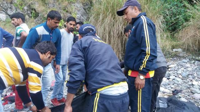 Rescue workers at the accident spot in Tehri Garhwal district. (HT Photo ) Rescue workers at the accident spot in Tehri Garhwal district. (HT Photo )