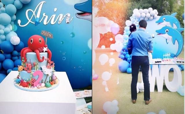 Arin’s birthday cake (left) and in the arms of her father Rahul Sharma at the party (right).