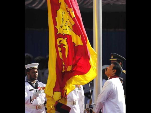 Sri Lankan President Mahinda Rajapaksa hoists the national flag during a parade celebrating Sri Lanka's 64th Independence Day in Anuradhapura. AP