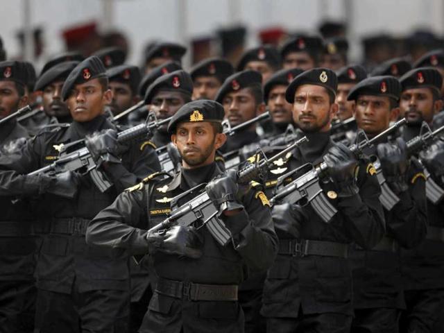 Sri Lankan Navy's Special Boat Unit personnel march during a parade celebrating Sri Lanka's 64th Independence Day, marking the country's independence from British colonial rule in 1948, in Anuradhapura. AP