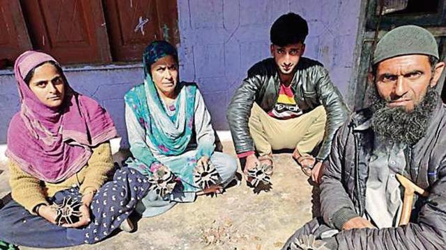 Villagers show shells fired from across the border in Uri. (HT Photo ) Villagers show shells fired from across the border in Uri. (HT Photo )