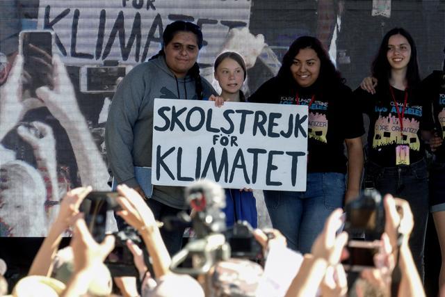 Climate activist Greta Thunberg, second from left, holding a sign, poses photos with other activists during a student-led climate change march in Los Angeles on Friday. (AP) Climate activist Greta Thunberg, second from left, holding a sign, poses photos with other activists during a student-led climate change march in Los Angeles on Friday. (AP)