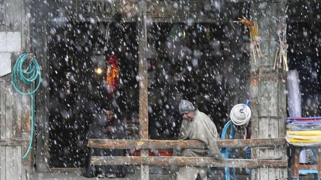 Men look out from a shop during the first snowfall of the season in Sonamarg, some 90 kilometers from Srinagar, Jammu and Kashmir. (Waseem Andrabi/HT Photo) Men look out from a shop during the first snowfall of the season in Sonamarg, some 90 kilometers from Srinagar, Jammu and Kashmir. (Waseem Andrabi/HT Photo)