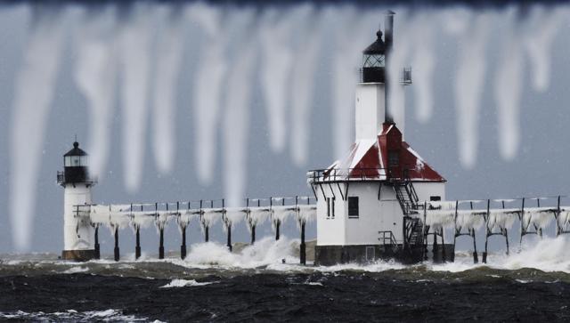 Snow and ice accumulates on the St. Joseph Lighthouses, Tuesday, Nov. 12, 2019, as a fall snow storm moves through St. Joseph, Michigan. (AP)